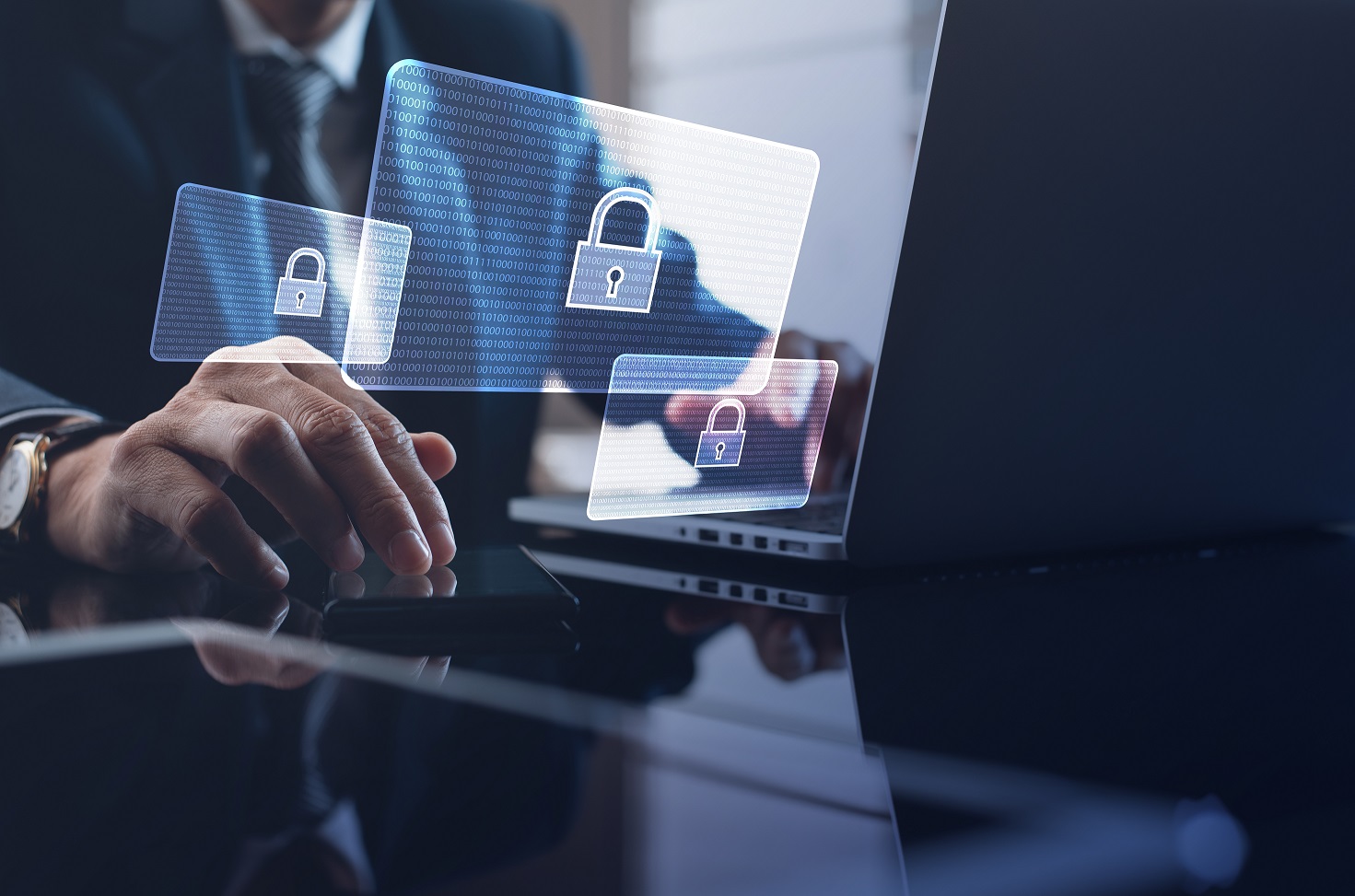 Un hombre de negocios utiliza una computadora portátil con gráficos de candados digitales, simbolizando la ciberseguridad.