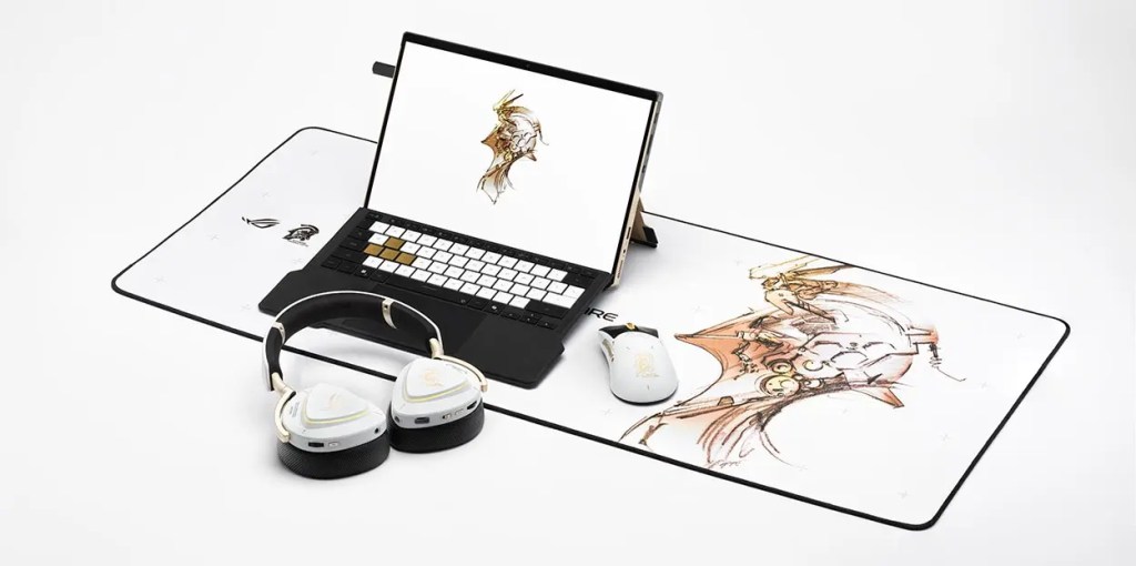 Un escritorio con un laptop abierto mostrando una ilustración, un mouse y auriculares de gaming, y una alfombrilla de mouse con un diseño artístico.