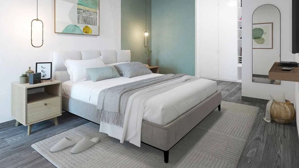 Habitación moderna con cama grande, mesita de noche de madera, decoraciones minimalistas y una pared verde.