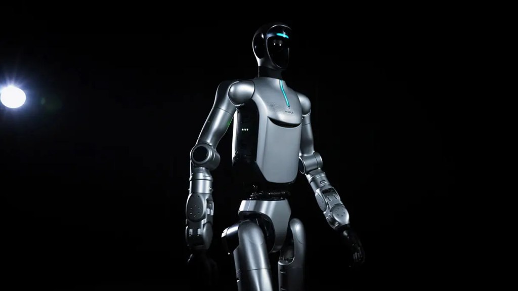 Un robot humanoide de diseño futurista iluminado en un fondo oscuro.